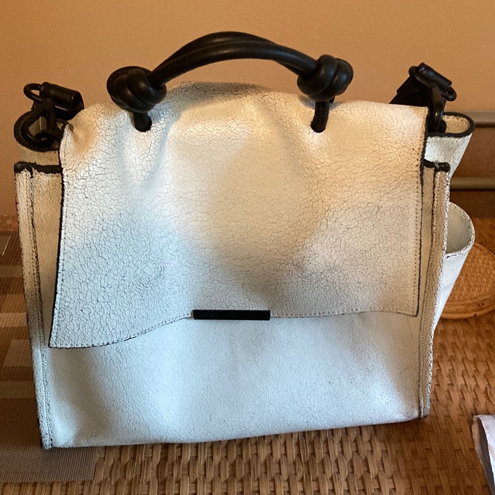 Large white distressed leather Daniella Lehavi handbag with shoulder strap.